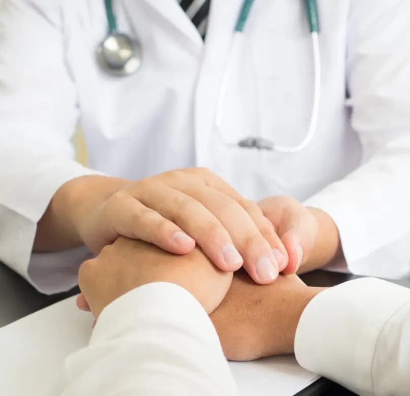 Doctor holding patient's hand